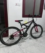 two bicycles Full-suspension mountain bike with a 27 red and black